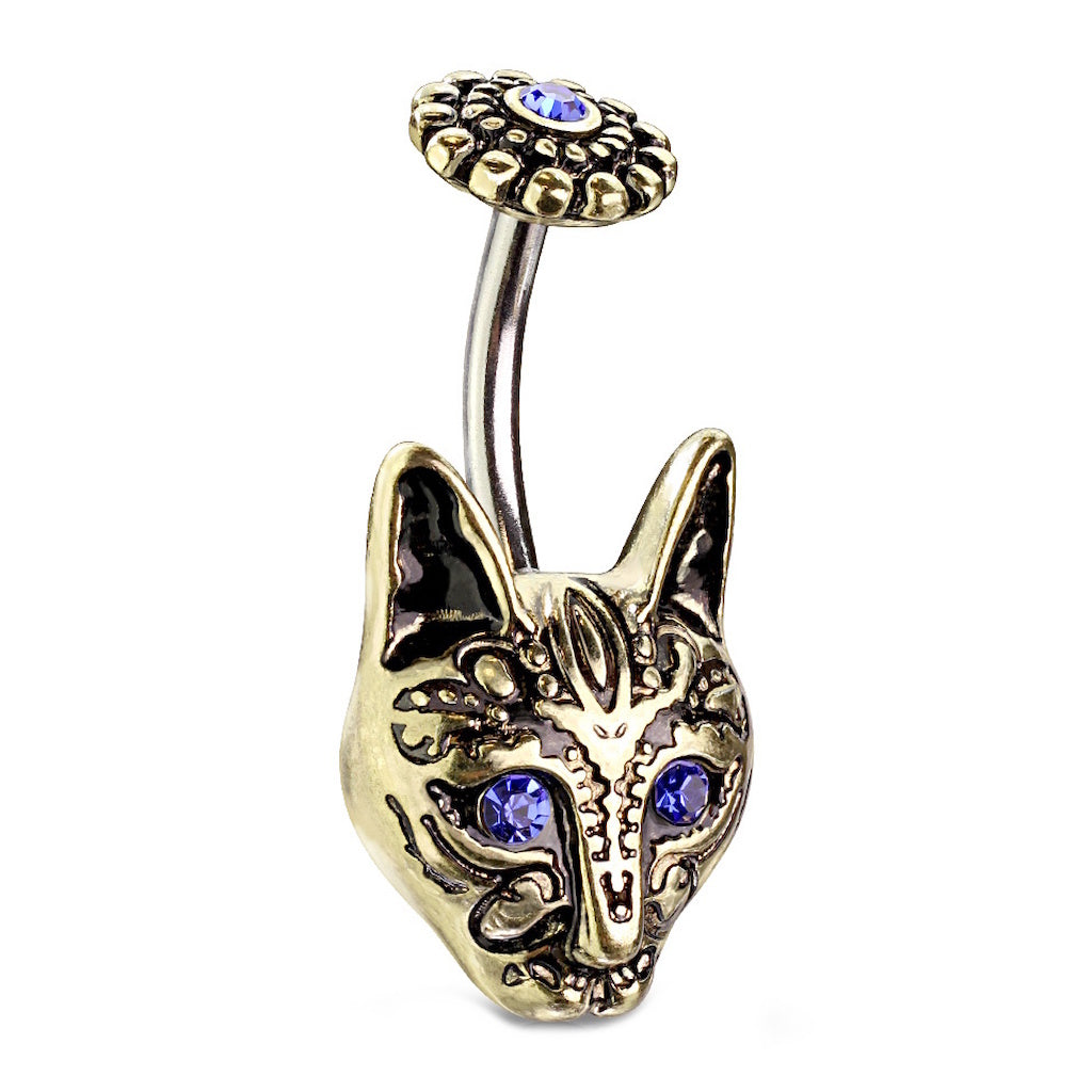 An antique gold tone tribal cat belly ring with blue crystal eyes pictured against a white background.