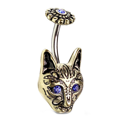 An antique gold tone tribal cat belly ring with blue crystal eyes pictured against a white background.