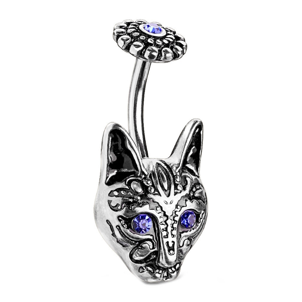 An antique silver tone tribal cat belly ring with blue crystal eyes pictured against a white background.
