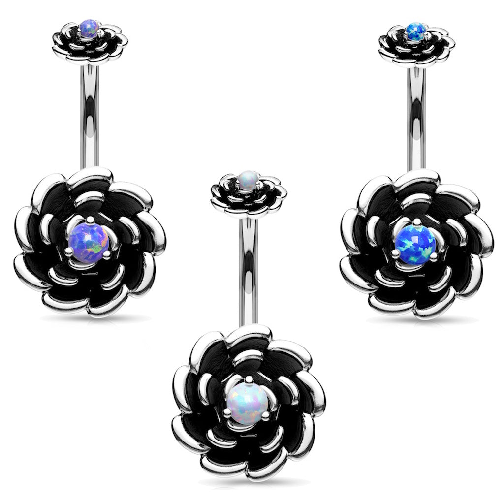 Set of three antique silver rose belly button rings with a different color of opal in the center of each on a white background.