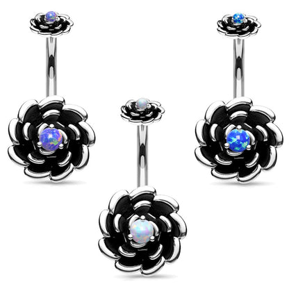 Set of three antique silver rose belly button rings with a different color of opal in the center of each on a white background.