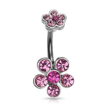 A flower belly button ring with pink gemstone petals on a white background.