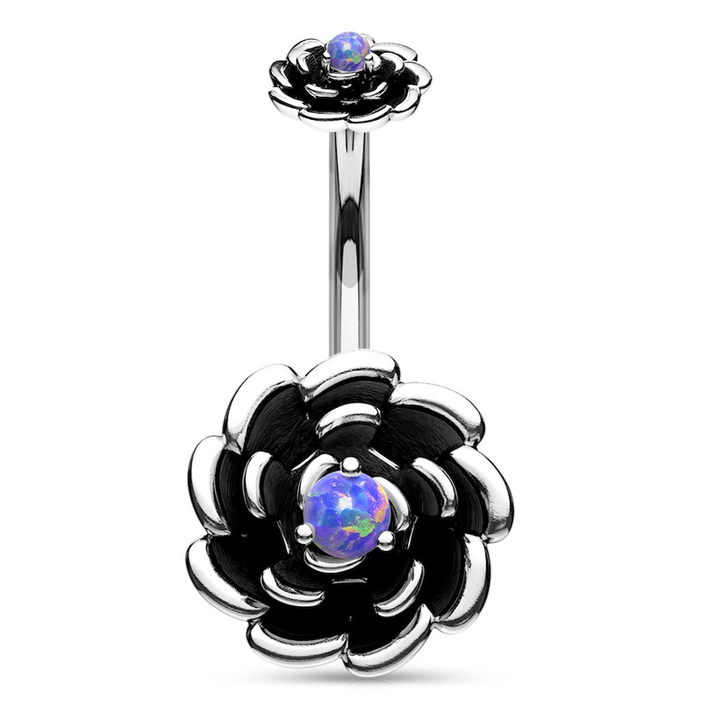 Navel ring with silver-colored flower design and purple synthetic opal in the center on a white background.