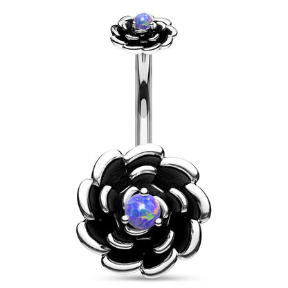 Navel ring with silver-colored flower design and purple synthetic opal in the center on a white background.