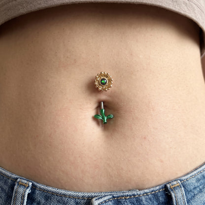 A sunflower belly button ring in the belly piercing of a female model.