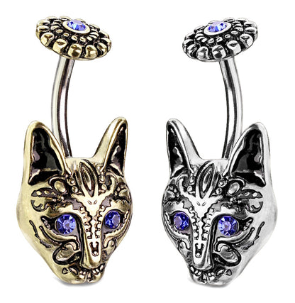 A pair of antique tone tribal cat belly rings with blue crystal eyes pictured against a white background.