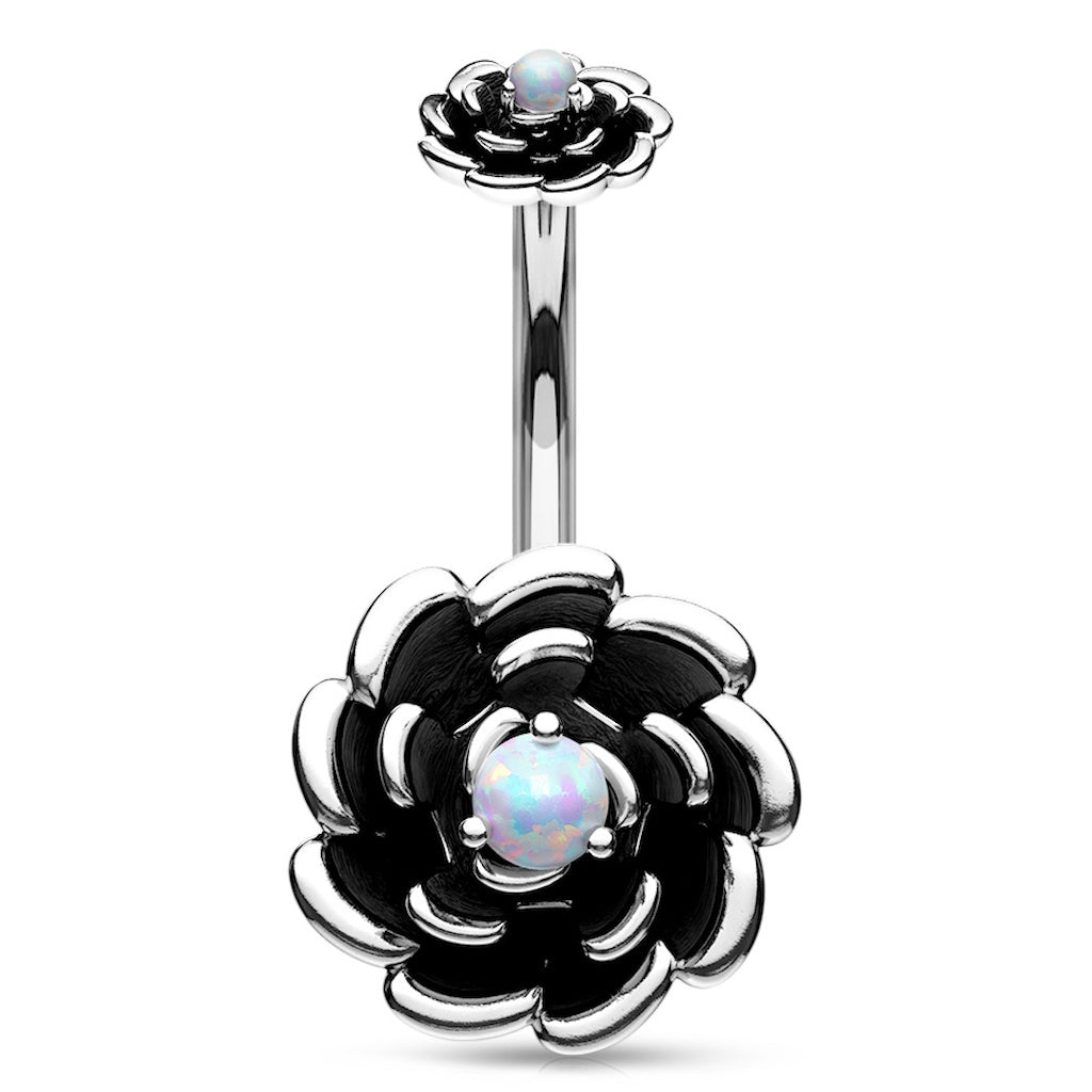 Navel ring with silver-colored flower design and white synthetic opal in the center on a white background.