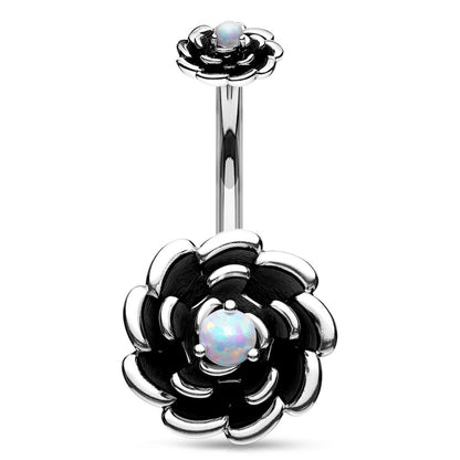 Navel ring with silver-colored flower design and white synthetic opal in the center on a white background.